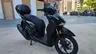 Honda SH350i negra con baúl en ciudad