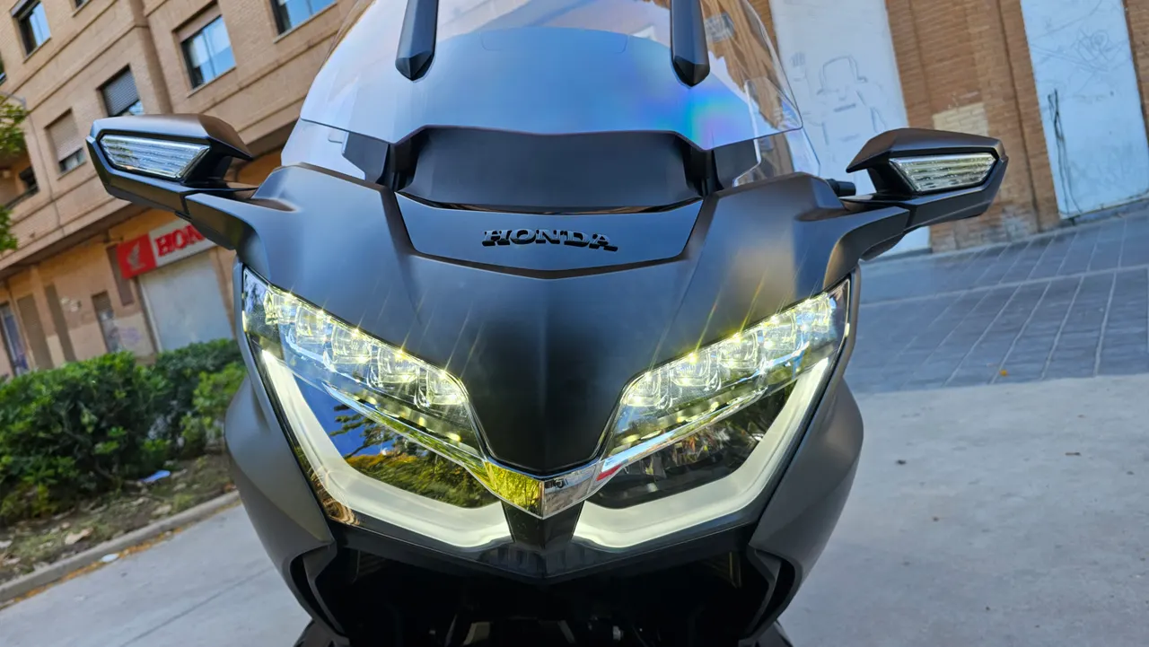 Vista frontal de Honda GL1800 Gold Wing DCT negra con luces LED encendidas.
