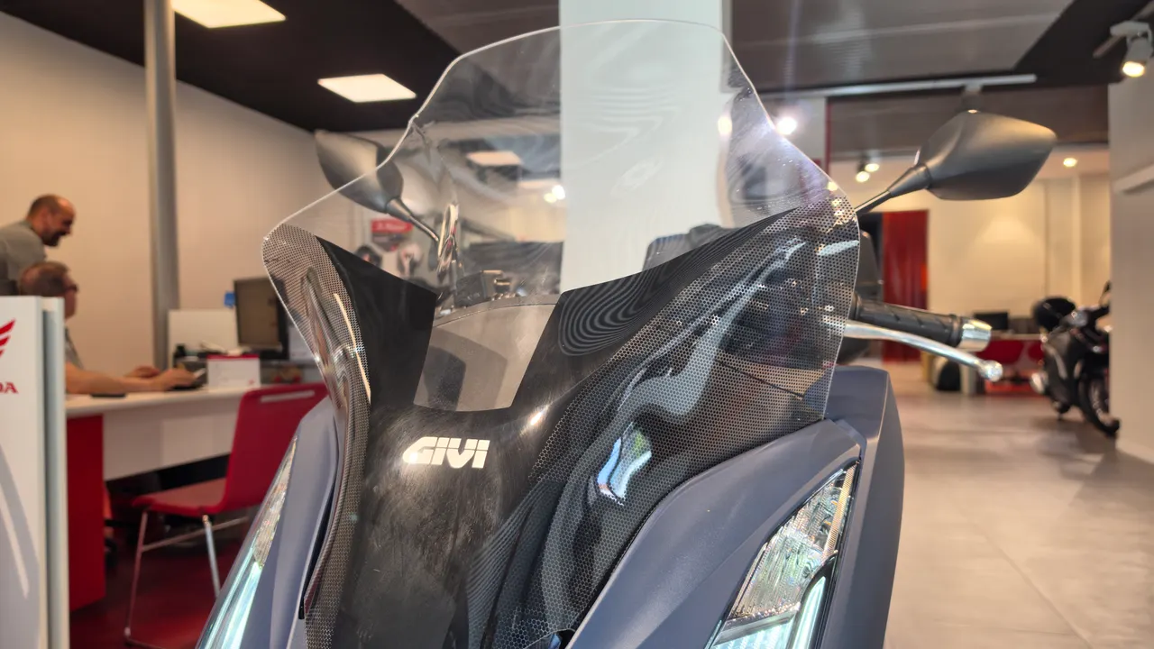 Detalle frontal de una moto Honda PCX 125 con parabrisas Givi