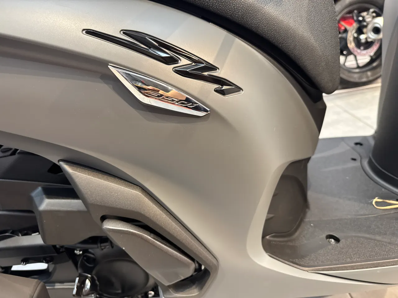 Detalle lateral de la Honda SH 350i en color gris rock mate