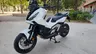Honda X-ADV blanca aparcada en una acera urbana