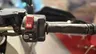 Detalle del manillar de una moto Honda X-ADV con el botón de arranque y controles de marcha.