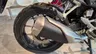 Detalle de la rueda trasera y el sistema de escape de una moto Honda NX500.