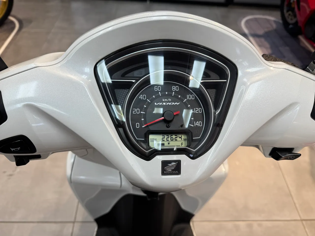 Cuadro de instrumentos de una moto Honda Vision de color blanco