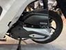 Detalle del motor y rueda trasera de una moto Honda Vision